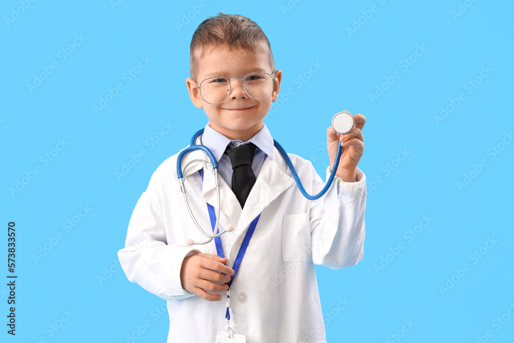 Cute little doctor with stethoscope on blue background