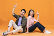 © Timeimage - Young Asian couple sitting on background