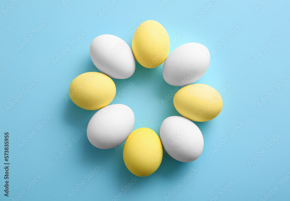 Composition with painted and natural Easter eggs on color background
