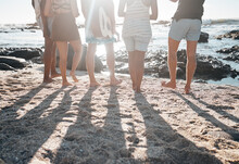 Friends, Back Or Standing Legs On Beach, Sand Or Ocean Sea In Social Gathering, Group Vacation Or Summer Holiday With Guitar. Men, Women Or Diversity People With Musical Instrument In Travel Bonding