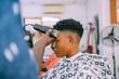 A young queer masculine woman getting a haircut