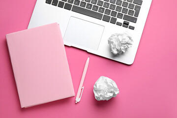 Wall Mural - Blank book, pen, crumpled paper balls and laptop on pink background. World Poetry Day celebration