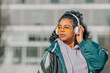 © carballo - girl with headphones and sunglasses listening to music on the street
