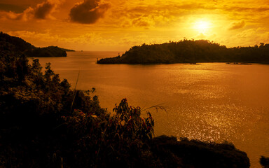 Wall Mural - Golden hour sunset with sea and island