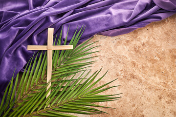 lent season, holy week and good friday concept. palm leave and cross on stone background