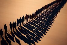 A Long Shadow Of A Group Of People Standing In A Line On A Beach With A Sky Background Shadows A Photo Land Art