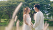 © ChayTee - Young adult fiance asia lover man and woman happy begin couple life hold two hands flirt sweet care touch. Asian people bride groom fall in love relax talk swear with trust hope on newlywed family day