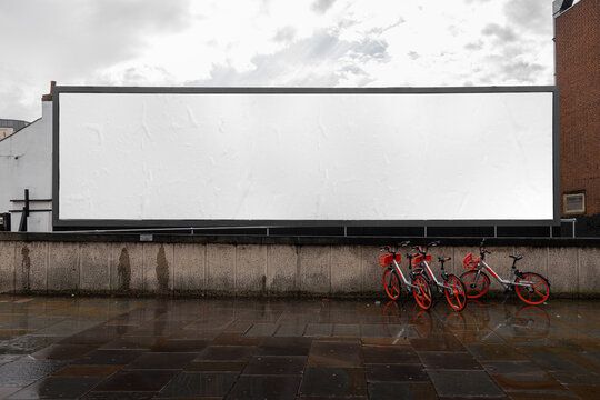 blank billboard sign mockup in the urban environment, on the facade, empty space to display your adv