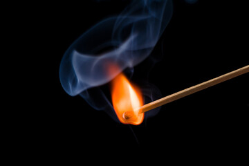 Lighting matches at the moment when it explodes. Burning match on black background. 