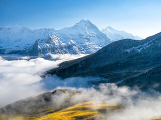 Poster - Mountains peaks and clouds in the valley. Natural landscape. Mountain range through the clouds. Landscape in the summertime.