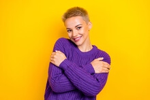 Photo Of Girlish Smiling Blonde Short Hair Lady Hug Herself Wear Purple Autumn Sweater Fresh Clothes Comfort Isolated On Yellow Color Background