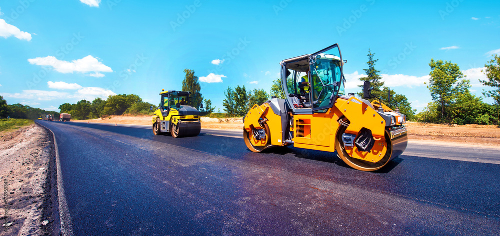 Asphalt Rool Work industrial landscape with rollers that rolls a new asphalt in the ...