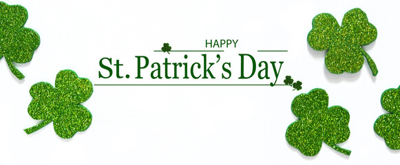 Happy St. Patrick's Day banner.Holiday background.St Patricks Day frame against a white background. Flat lay shamrocks.Copy space.Patrik's day banner