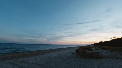 Wall Mural - Winter ocean on the beach after sunset time lapse