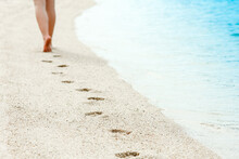 Beautiful Footprints In The Sand By The Sea Background