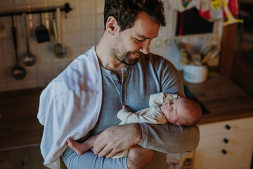 Wall Mural - Close-up of father holding his little son.