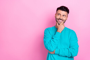 Wall Mural - Photo of young handsome positive guy wear stylish blue pullover touch chin think look empty space brand promo isolated on pink color background