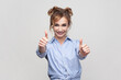 © khosrork - Woman showing like gesture, satisfied with something, keeps thumb raised, shows her agreement.