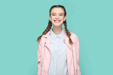 Wall Mural - Extremely happy joyful teenager girl standing looking at camera with toothy smile, smiles broadly.