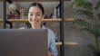 © RZ Images - Close up portrait of smiling asian teacher conducts an online lesson using laptop