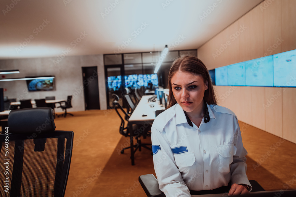 Female security operator working in a data system control room offices ...