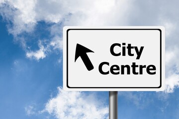 Road sign of city center on sky background