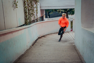 Women in sports clothes running in a modern urban environment et night time. The concept of a sporty and healthy lifestyle