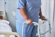 © Seventyfour - Close up of black senior woman leaning on walker support in hospital room, copy space