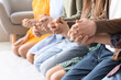 © Pixel-Shot - Group of people praying with Holy Bible on floor, closeup