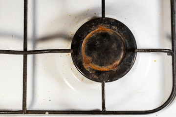 Rusty dirty burner on the gas stove.Dirty surface of the old gas stove view from above.