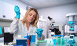 © tilialucida - Caucasian female scientist, biologist, biochemist works in research laboratory.Caucasian worker performs experiments in pharmaceutical or academic research facility.