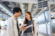 © Kawee - Asian young couple passenger walk in airport terminal to boarding gate.