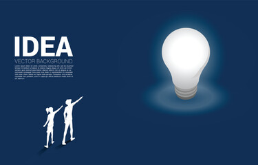 Poster - Silhouette of businessman and businesswoman standing and point finger on light bulb . Business Concept of creative idea and solution.