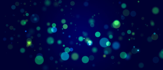 Abstract bokeh lights on dark blue background.