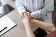 © Jirapong - Portrait of a female doctor holding a patient's hand to encourage the fight against disease.