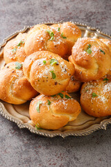 Wall Mural - Homemade hot fresh Garlic Knots buns closeup on the plate on the table. Vertical