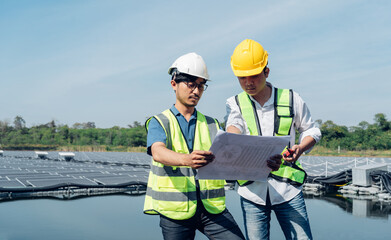 Team of engineers wearing a uniform inspect and check solar cell panel, solar cell is smart ecology energy sunlight alternative power factory concept.