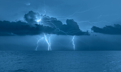 Fototapete - Beautiful landscape with lightning over the calm sea 