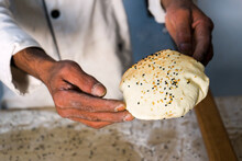 A Risen Taboon Bread Or Lafah, A Middle Eastern Flatbread, Being Held By The Baker As It Has Just Come Out Of A Tabun Oven.