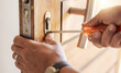 © Lumeez/peopleimages.com - Locksmith hands, maintenance and handyman with tools, home renovation and fixing, change door locks and closeup. Construction, building industry and trade with manual labour, vocation and employee