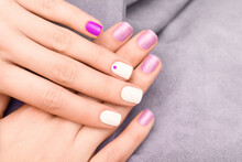 Various Hands Manicure, White, Purple And Pink Nail Polish With Rhinestones Nail Art. Nails Background Concept.