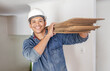 © Lumeez/peopleimages.com - Construction worker, home renovation and portrait of man holding wood for maintenance. Working, smile and house development project employee and builder or handyman for architecture or industrial job
