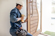 © Lumeez/peopleimages.com - Locksmith, man and maintenance, handyman with home renovation and fixing, change door locks with power tools. Construction, building industry and trade with manual labour, vocation and employee