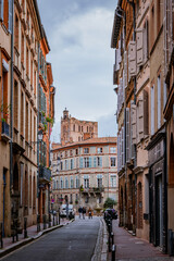 Wall Mural - Beautiful facades with bricks in Perchepinte street and the Saint Etienne cathedral bell tower in Toulouse old town, in the south of France (Haute Garonne)