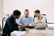 © Nuttapong punna - Office colleagues have a casual discussion. During a meeting in conference room, a group of business teem sit in the conference room new startup project..