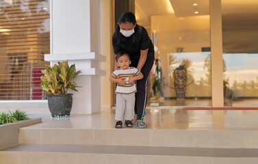 Wall Mural - Portrait of a happy young Asian family of mother and daughter on vacation in a luxury hotel, vacationing together