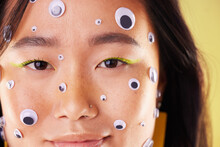 Gen Z, Eyes Sticker Art And Portrait Of An Asian Woman With Makeup And Colorful Cosmetics. Creative Googly Eye Application, Style Influencer And Cosmetic Creativity Of A Model With Studio Background