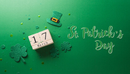 Wall Mural - Happy St Patrick's Day decoration concept made from shamrocks ( clover leaf), wooden calendar and leprechaun hat on green background.