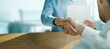 © ronstik - business people handshake in office. businessmen partnership, agreement and cooperation concept. banner with copy space