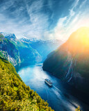 Fototapeta Psy - Breathtaking view of Sunnylvsfjorden fjord and famous Seven Sisters waterfalls, near Geiranger village in western Norway.